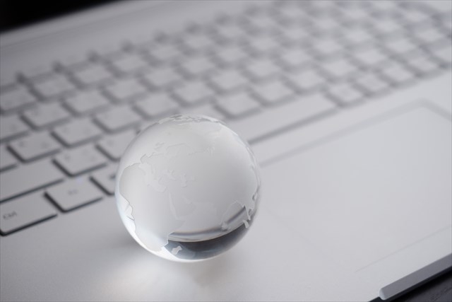 パソコンのキーボード上に置かれた美しく透明な球体